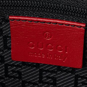 Gucci, a red leather handbag.