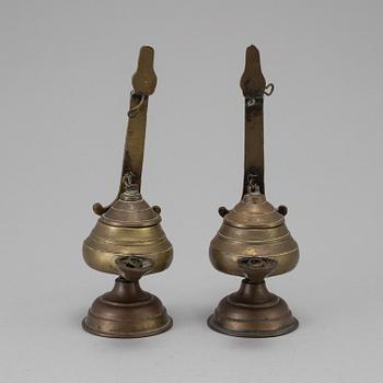 A pair of 17th/18th century bronze oil lamps.