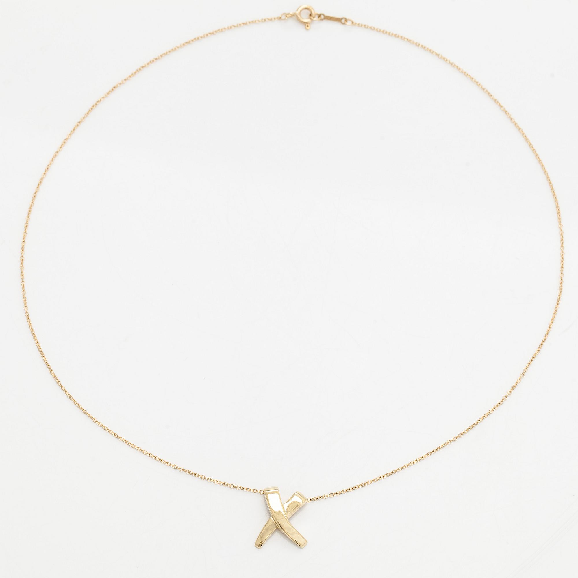 Tiffany & Co, Paloma Picasso, an 18K gold "X Kiss" necklace.