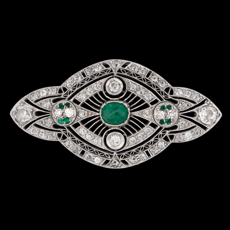 A cabochon cut emerald and old cut diamond brooch, c. 1915.