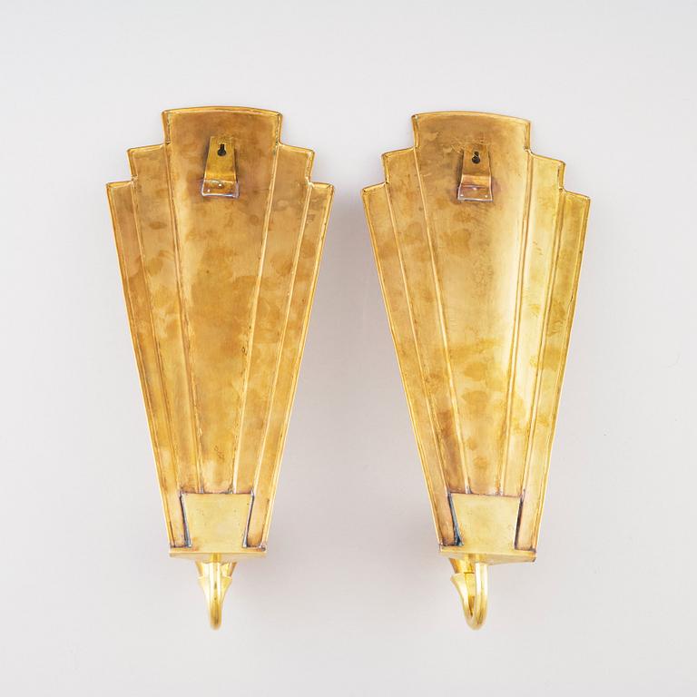 Lars Holmström, a pair of Swedish Grace brass wall sconces, Arvika.