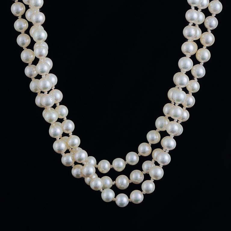 Three strand cultured pearl necklace, clasp with diamonds.