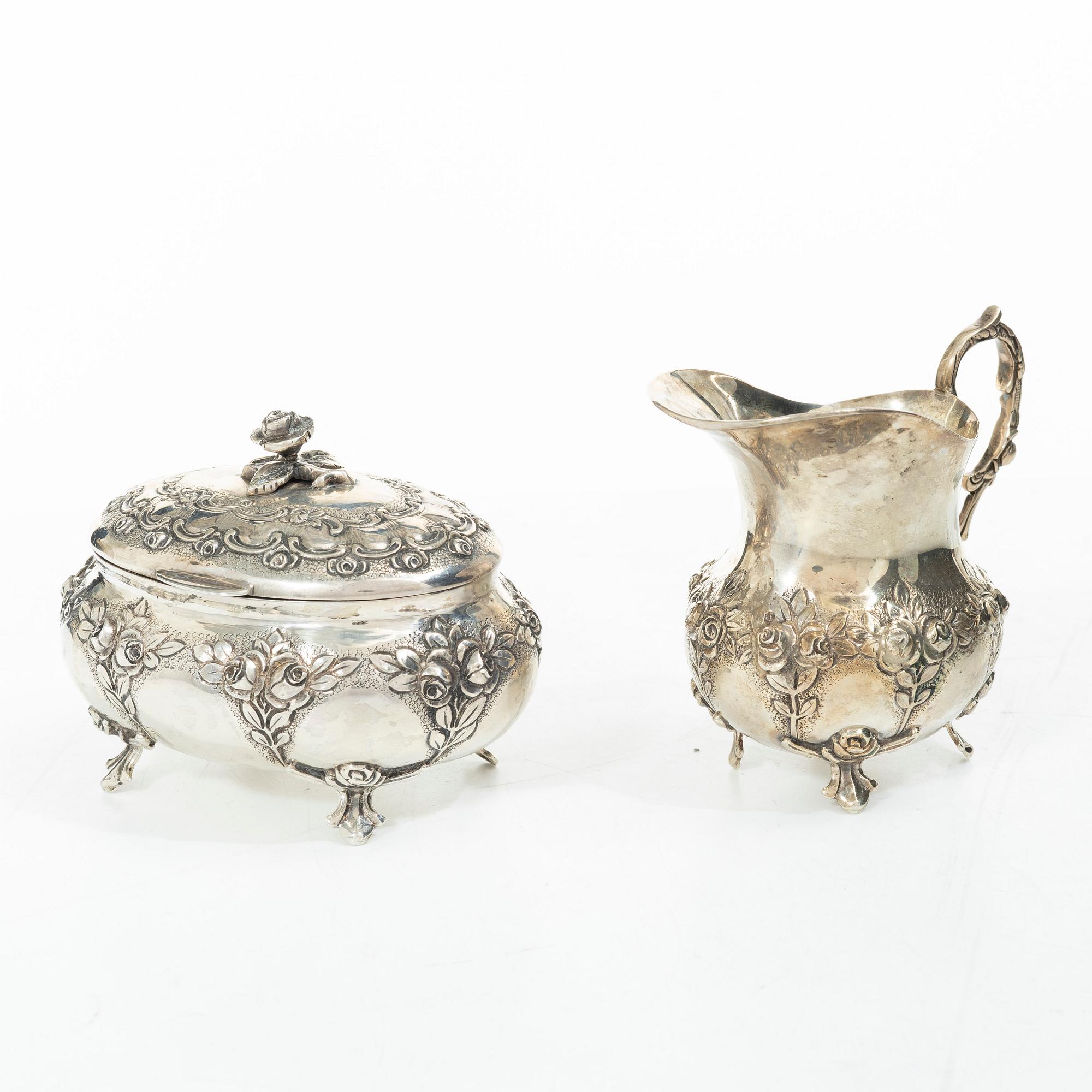 A silver sugar bowl, creamer and sugar tongs, 20th century.