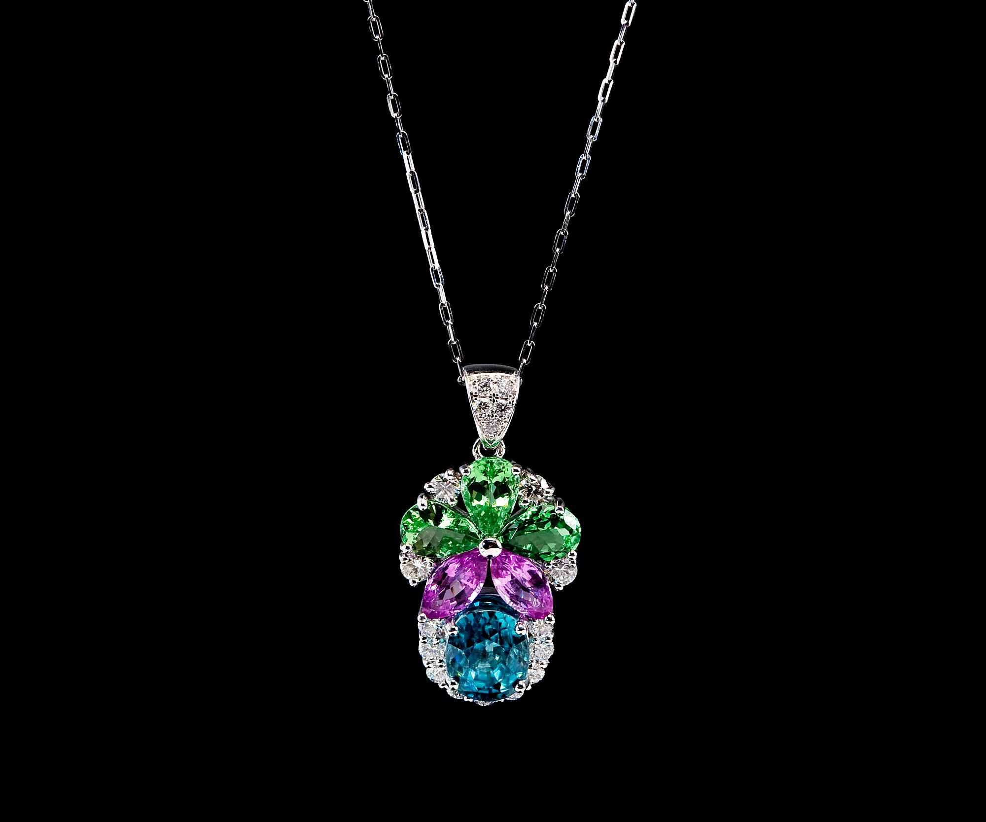 A PENDANT, Cambodian blue zircon 4.69 ct, 2 pink sapphires 1.38 ct, 3 green tsavoriters 2.15 ct.