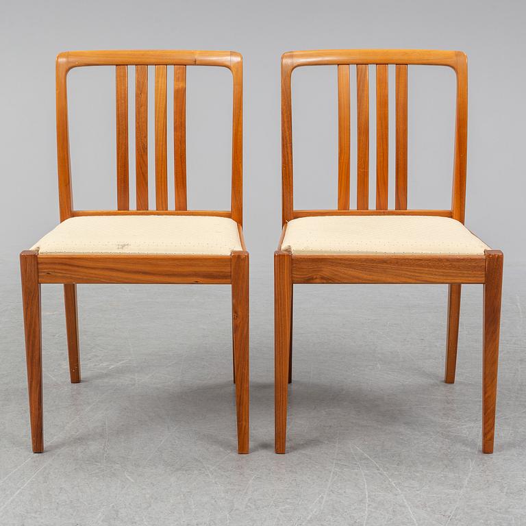 A 1950/60s teak and valnut table and four chairs.