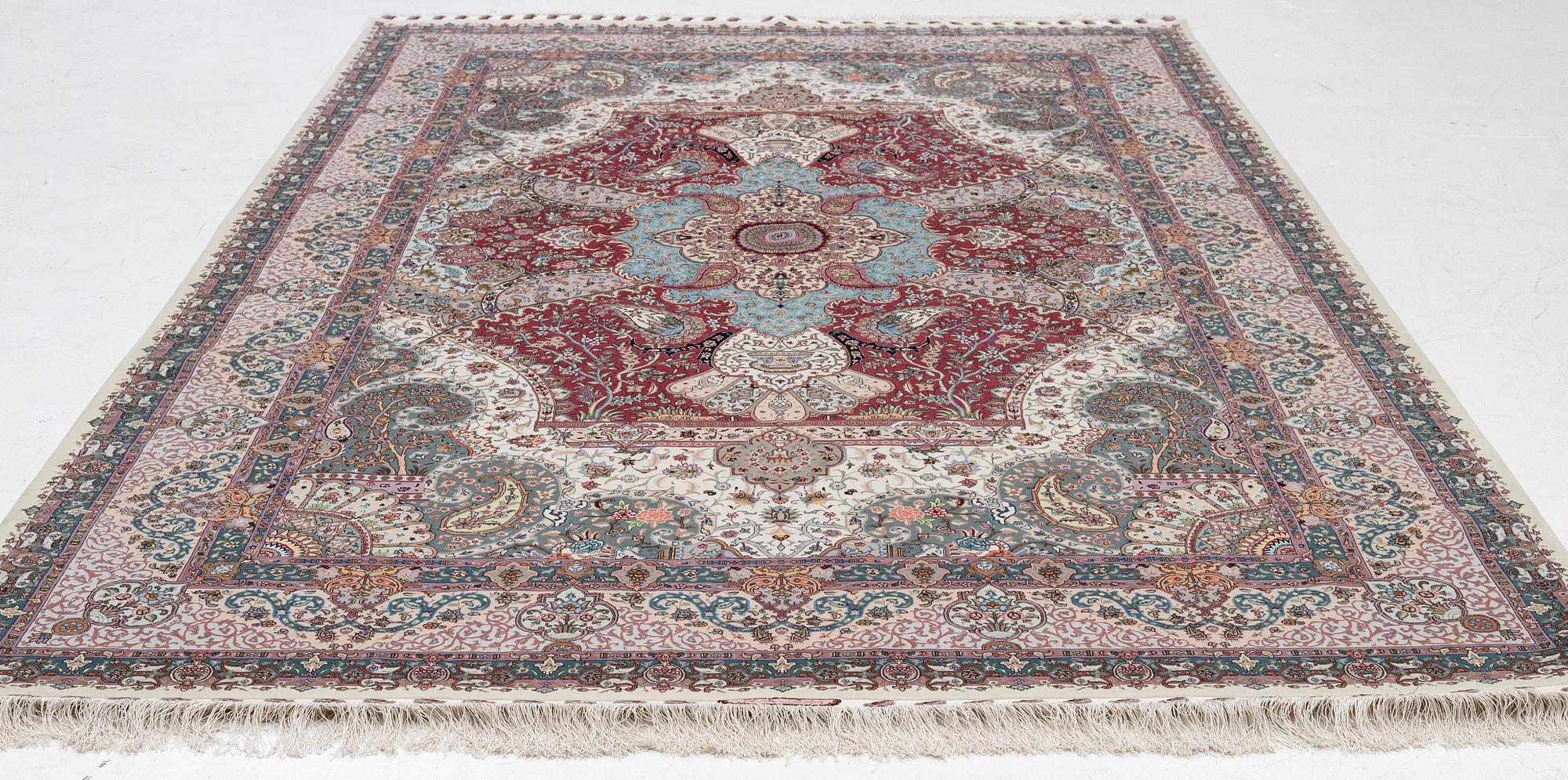 A Tabriz carpet, 210 x 195 cm. signed.