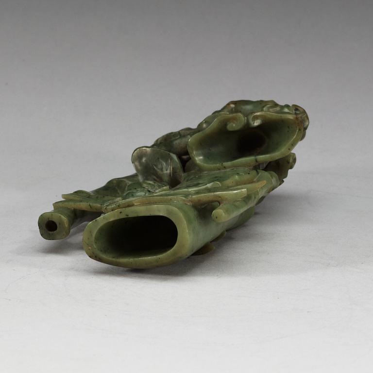 A  carved green stone sculpture, late Qing dynasty.