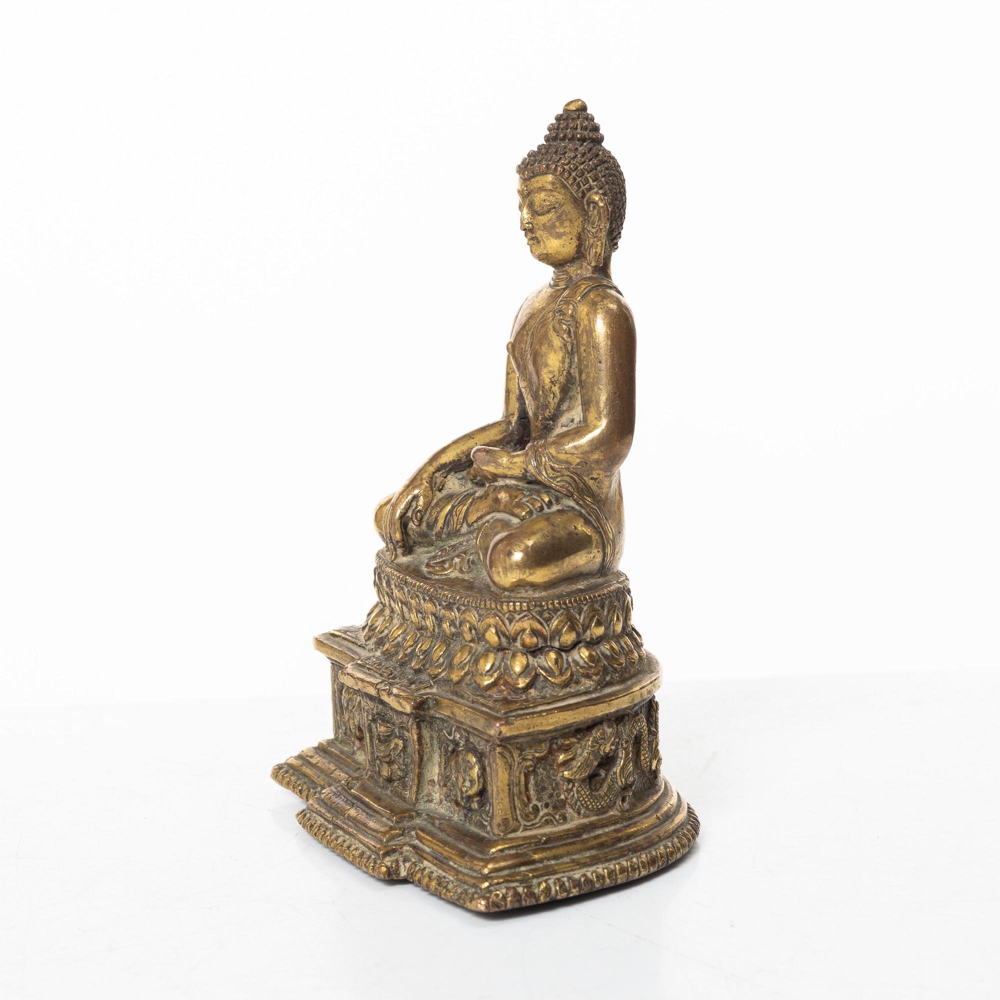 A gilt bronze figure of a Buddha, Nepal, 20th century.