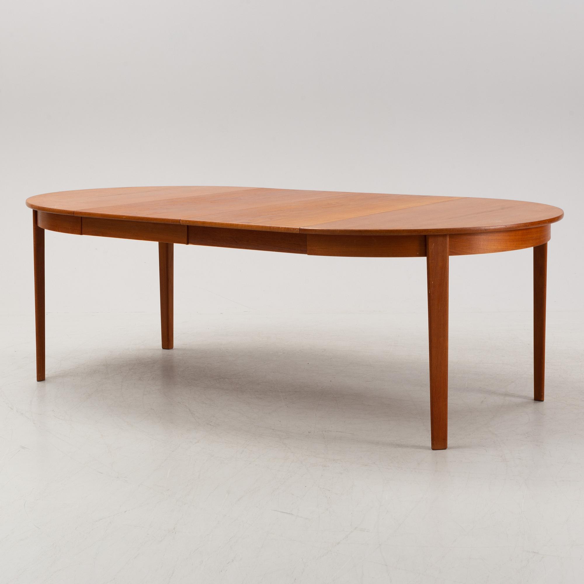 A 1950's/60's teak-veneered dining table.