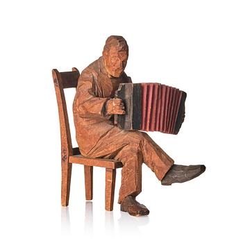 Axel Petersson Döderhultarn, Seated accordionist.