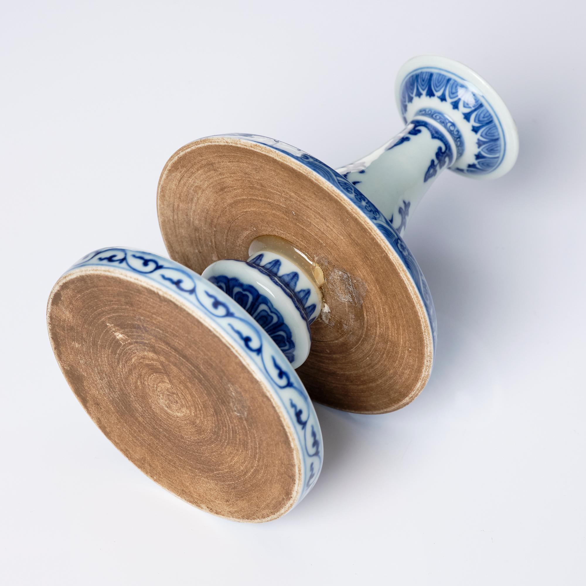 A pair of blue and white pricket candle sticks, with a poem, Qing dynasty with a Qianlong mark and of the period.