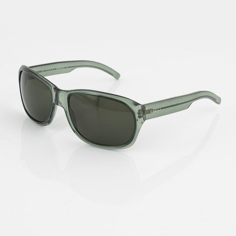 Gucci, a pair of green sunglasses.