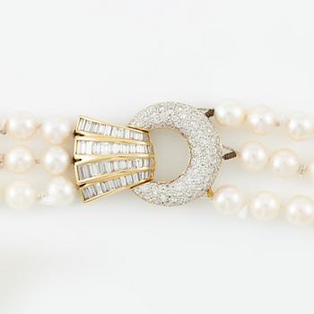 Pearl necklace, three strands of cultured pearls, clasp in gold set with baguette and brilliant-cut diamonds.