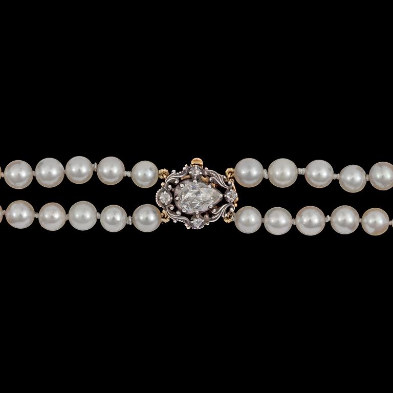A two strand cultured pearl necklace, 7,4 mm, rose cut diamond clasp.