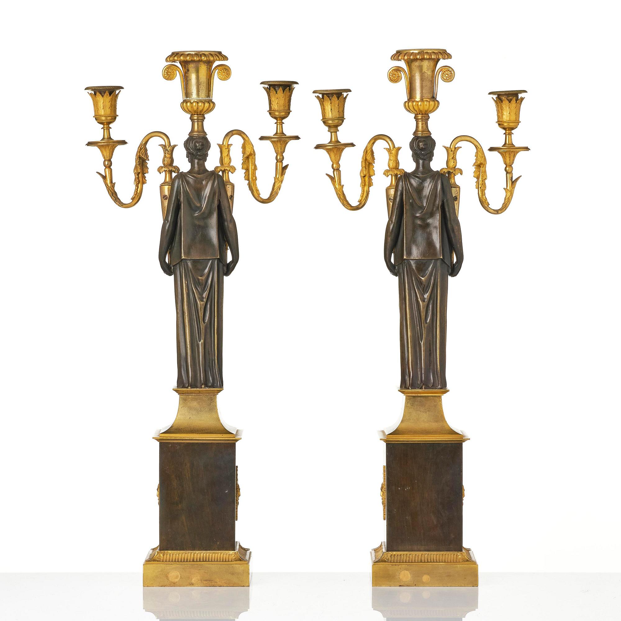 A pair of French Empire ormolu three-branch candelabra, Paris, early 19th century.