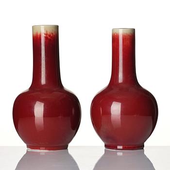 A set of two sang de boef glazed vases, late Qing dynasty, circa 1900.