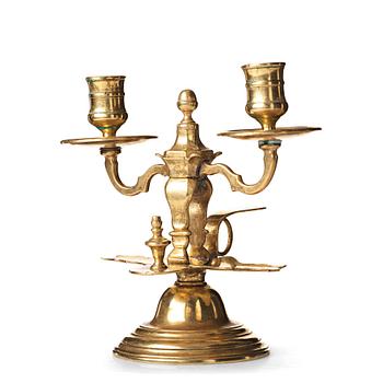 125. A late Baroque twin-light brass candlestick, early 18th century.