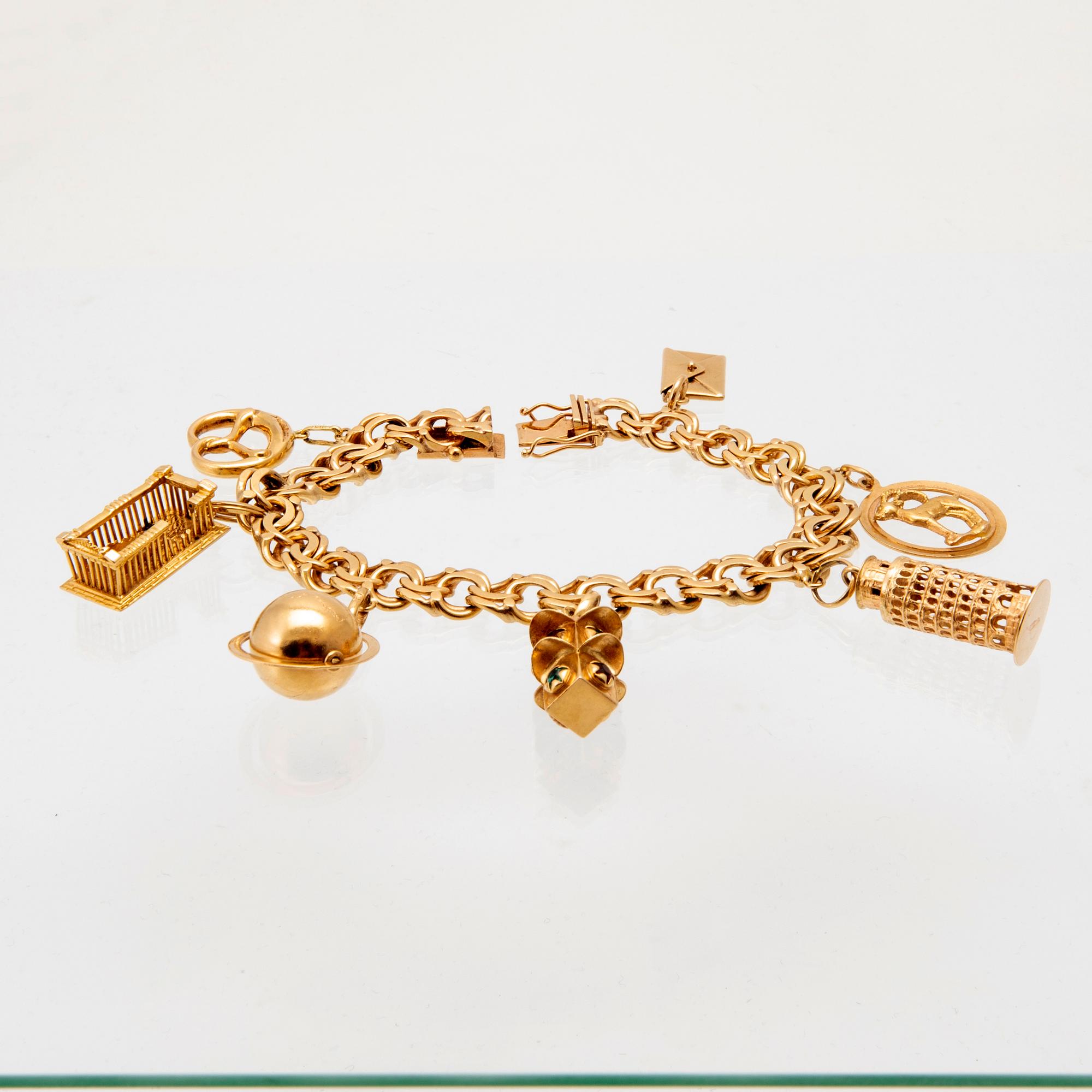 An 18K gold bracelet with charms.