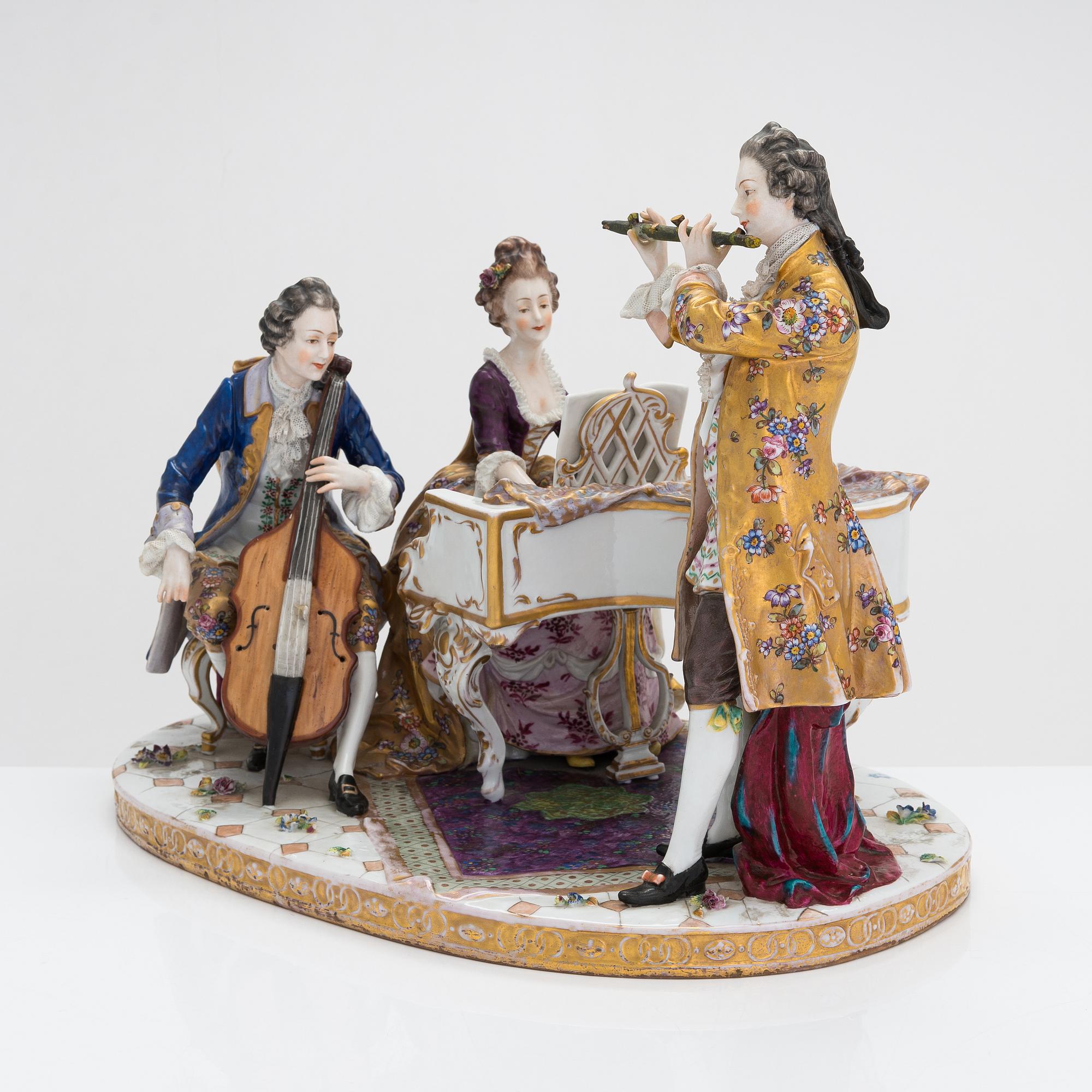 A Volkstedt porcelain musical trio figurine, mid-20th century. Length 40 cm.