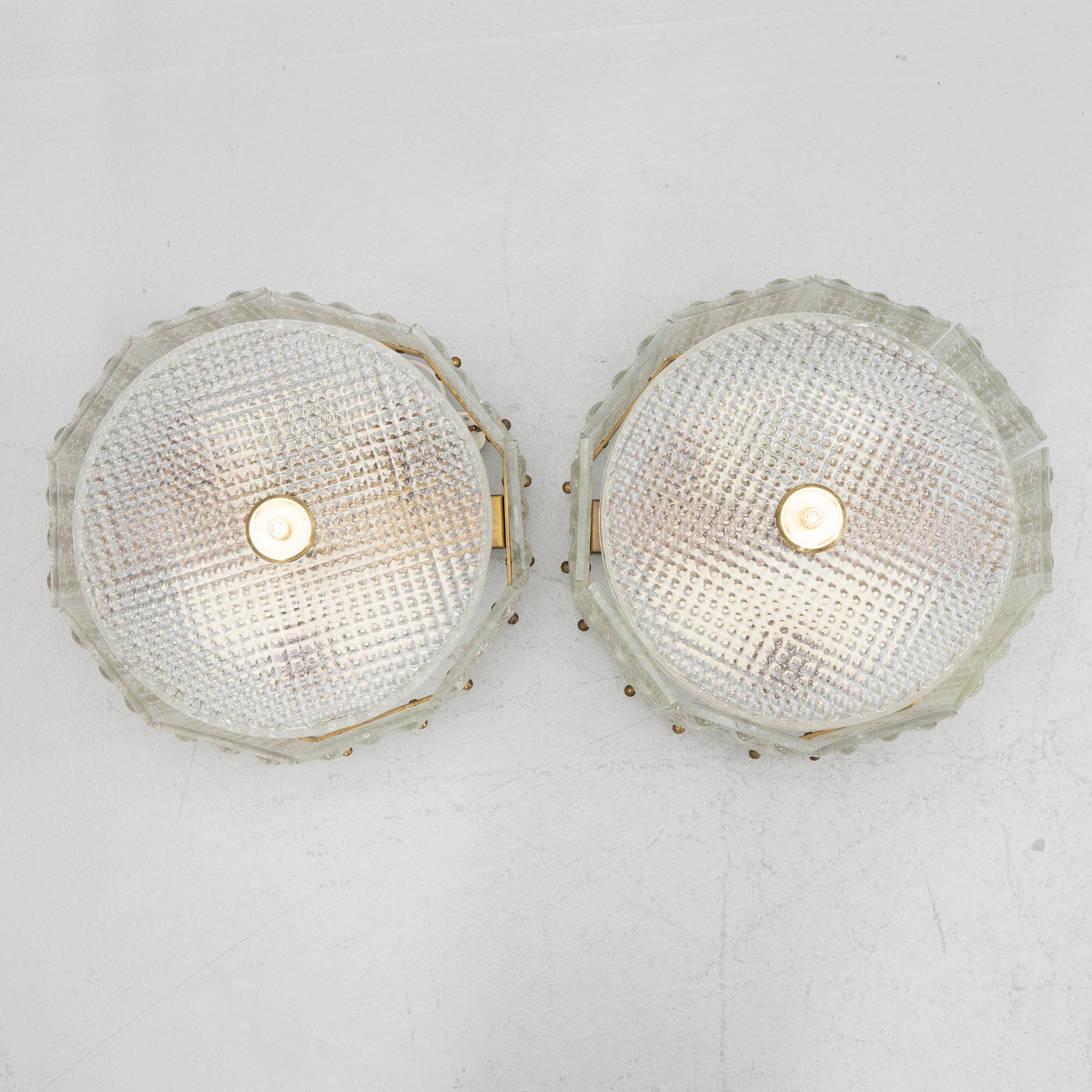 Carl Fagerlund, a pair of glass and brass ceiling lamps, Sweden, second half of the 20th century.