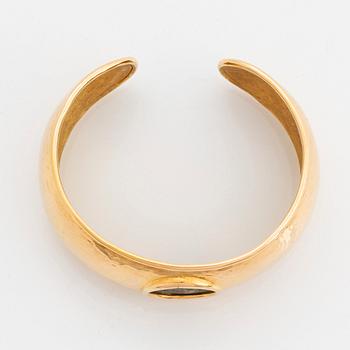 An 18K gold bangle set with an ancient coin.