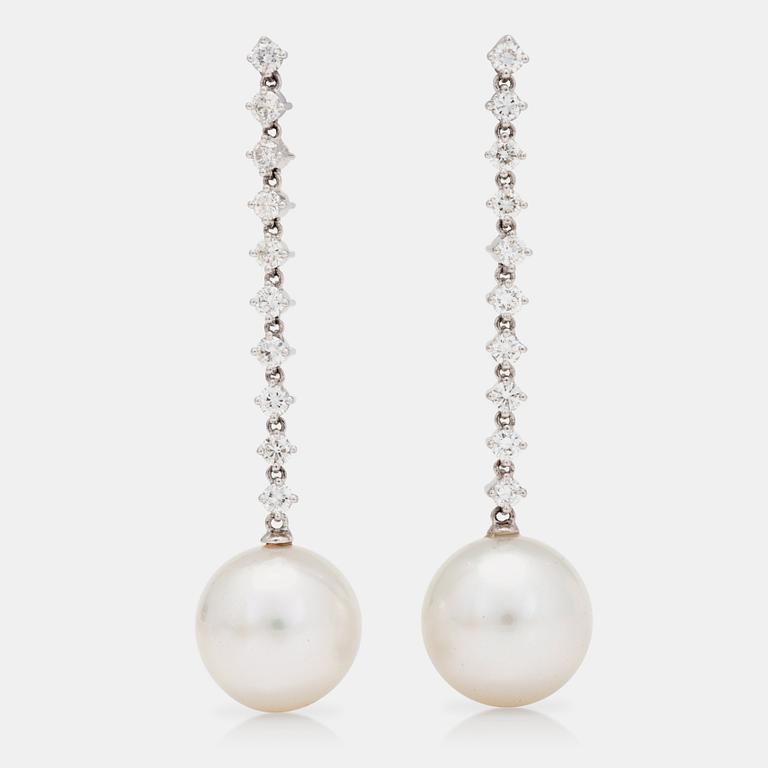 A pair of cultured South Sea pearls and brilliant-cut diamond earrings. Total gem-weight circa 1.20ct.