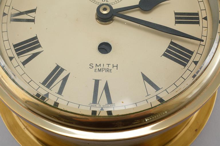 A wall clock from Smith Empire and a barometer, made in the fourth quarter of the 20th century.