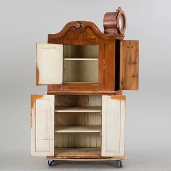 An 18th century cabinet with a clock.
