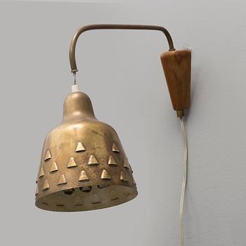 a 1950's brass and teak wall light.