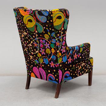 A 1960's/70's wing-chair with rosewwod legs.