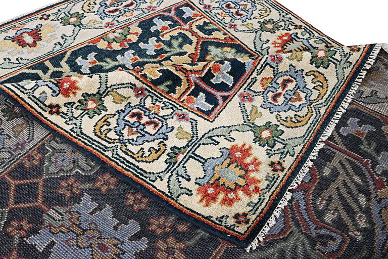 An oriental carpet with Mamluk design, c. 308 x 250 cm.