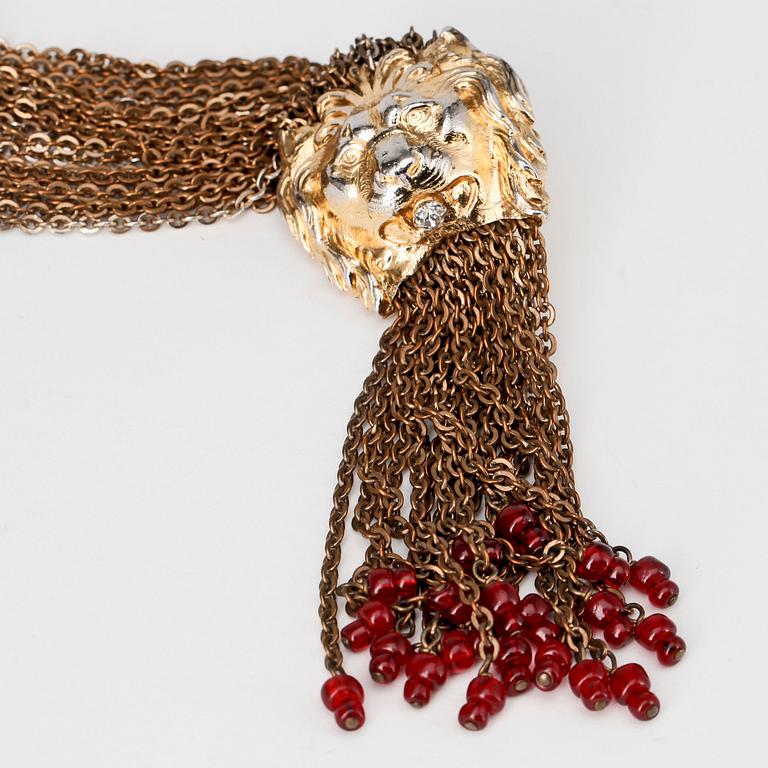 CHANEL, a gold colored metal necklace.