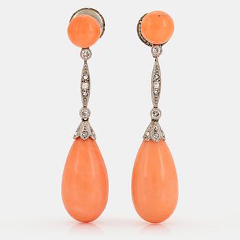 A pair of 14K white gold earrings with coral drops and old- and eight-cut diamonds.