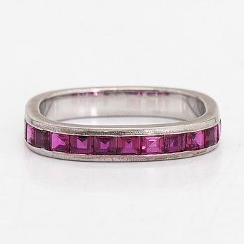 An 18K white gold eternity ring, with square-cut rubies.