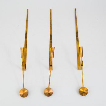 PIERRE FORSSELL,  three 'Pendeln' brass wall sconces from Skultuna.