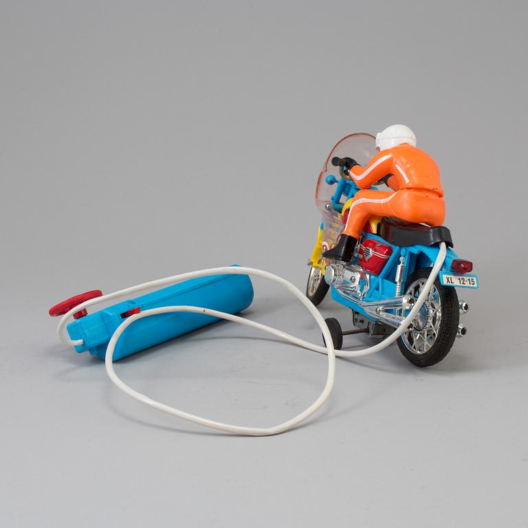 A 1970s battery operated toy racing auto cycle,Original "Junior" Product, Japan.