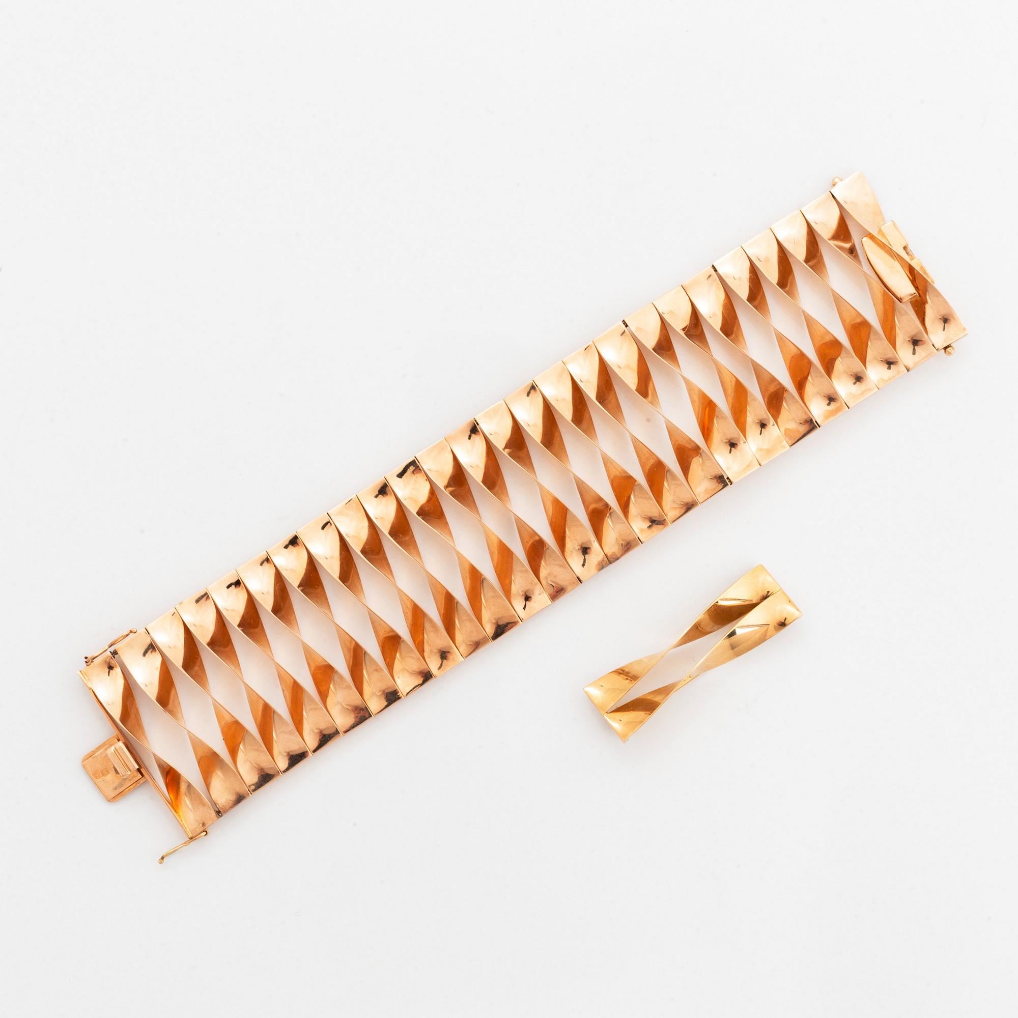 A 14K gold bracelet and a brooch.