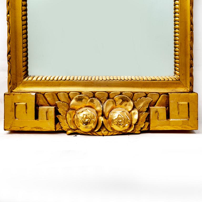 A gilded mid 1900s Gustavian style mirror.