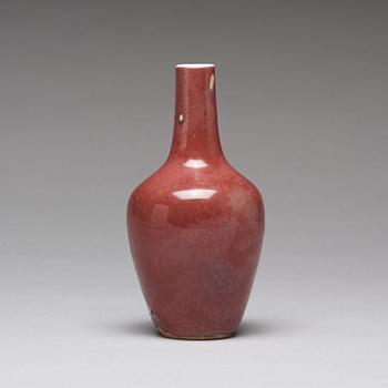 A sang de boef vase and bowl and an enamelled cup with cover and stand, Qing dynasty (1664-1912).