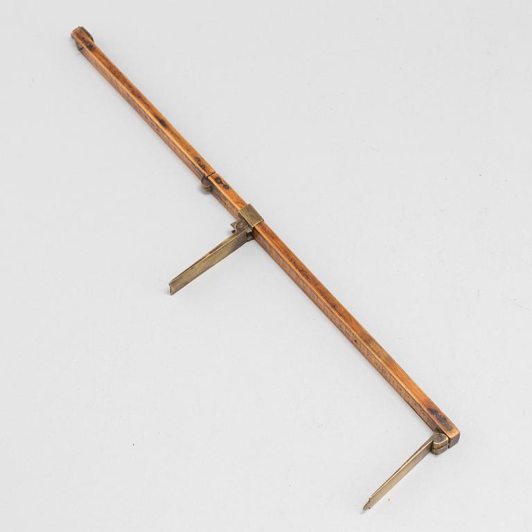 A 19th century wooden measuring stick.