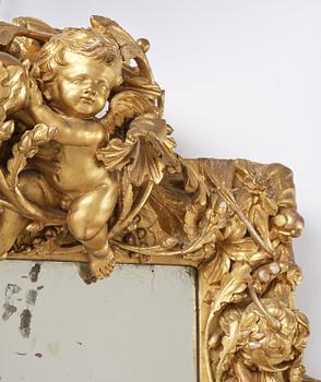 A presumably Dutch Louis XIV carved giltwood frame with mirror glass, in the style of Jean Le Pautre, late 17th century.