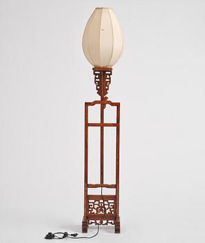 A Chinese wooden floor lamp, later part of the 20th century.
