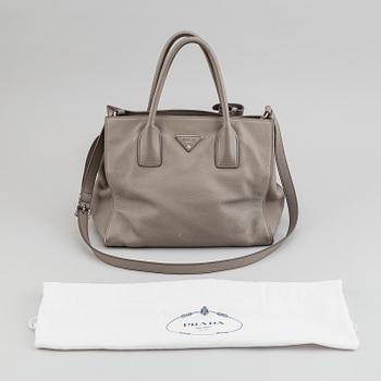 Prada, a leather handbag.