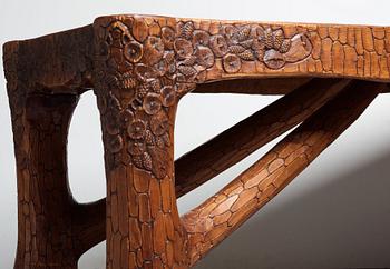 Gustaf Fjaestad, an Art Nouveau carved pine table, Arvika Sweden 1914, a double to the table in the Thiel Collection,