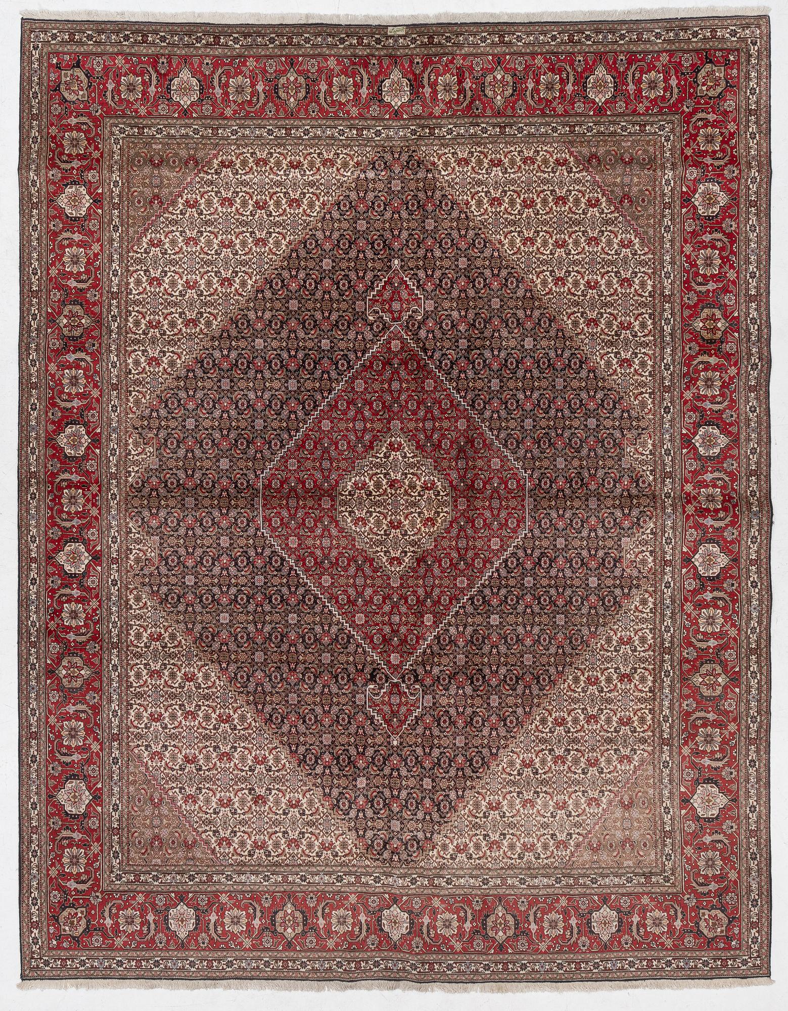 A signed Tabriz carpet, c. 385 x 300 cm.