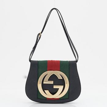 Gucci, a black leather and gold logo bag.