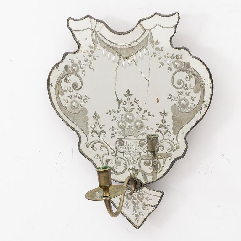 A North European rococo one-branch engraved glass girandole mirror, mid 18th century.