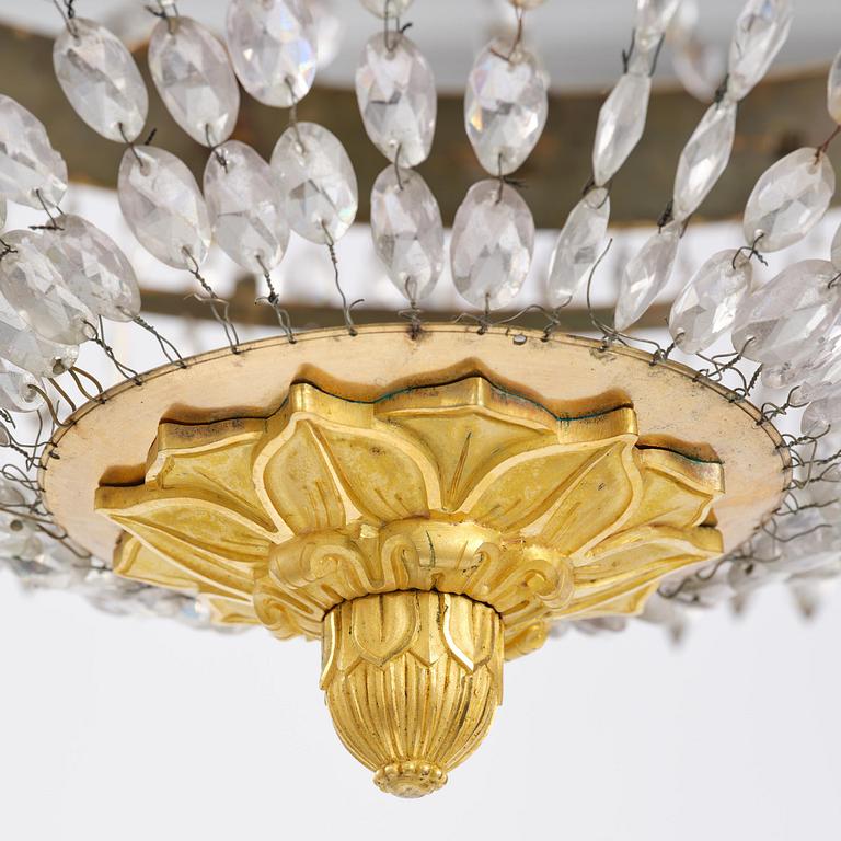 An French Empire eight-light gilt-brass and cut-glass chandelier.
