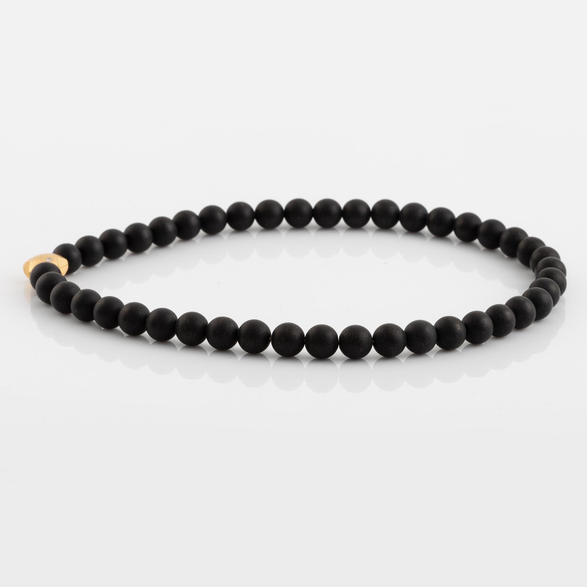Ole Lynggaard, black stone  bead necklace, clasp star 18K gold with brilliant cut diamond.