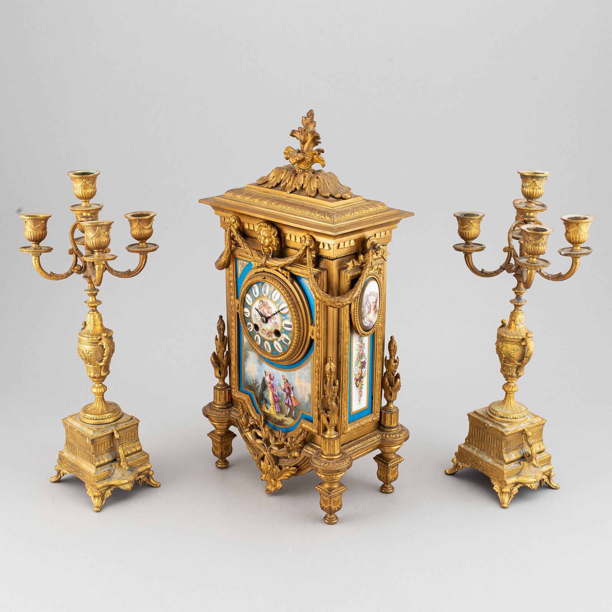 A late 19th century table clock and candelabra, probably France.